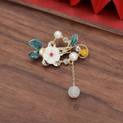Chinese - style flower tassel brooch with multiple flowers and beads, on wooden background