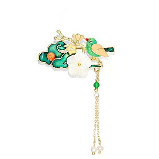 Azure bird-and-flower Chinese-style brooch with layered petals and silk tassels, on white background