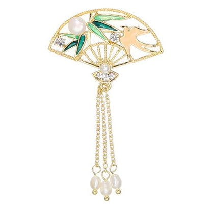 Green bamboo-patterned fan-shaped Chinese-style brooch with bird motif and jade tassels, on white background