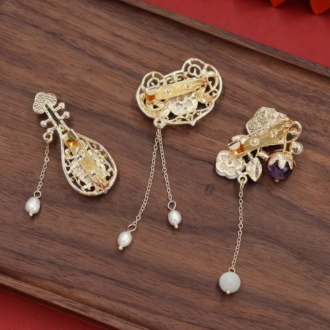 Set of Chinese - style flower tassel brooches, including lute - shaped and flower - shaped ones, on wooden background