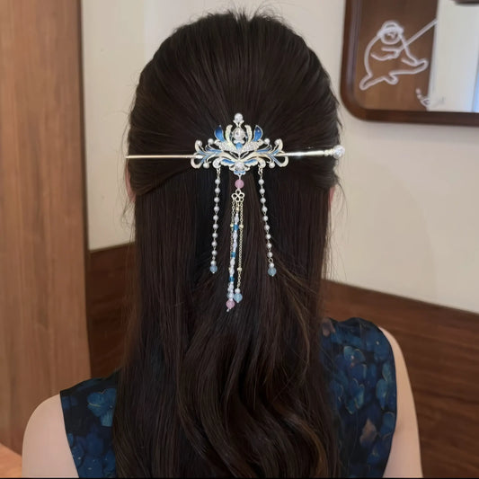 The full effect of the hairpin worn in a low bun hairstyle.