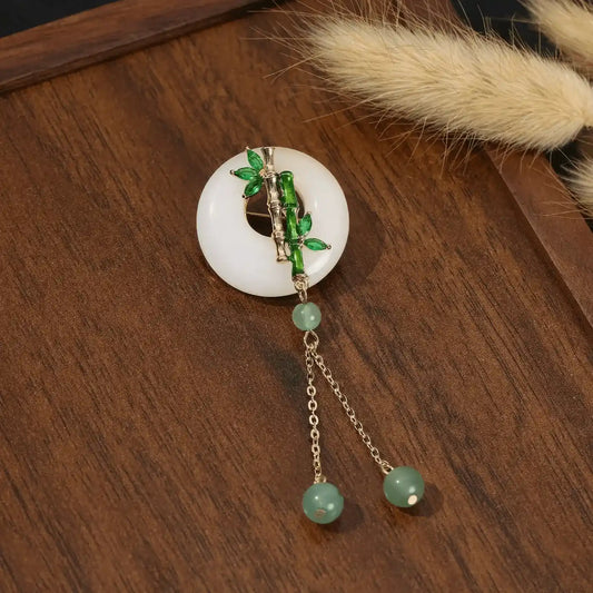 Chinese - style premium brooch with circular bamboo design, on wooden background