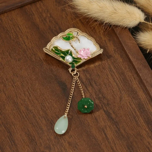 Chinese - style premium brooch with fan and flower design, on wooden background