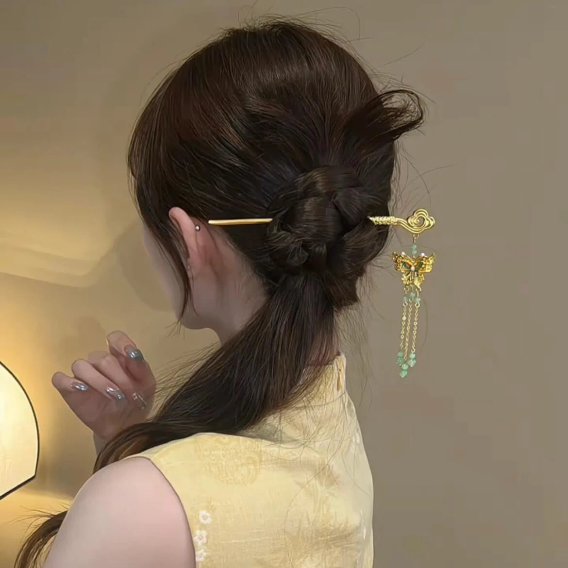 Golden cloud-butterfly hairpin worn in half-up hairstyle with yellow Qipao, side view