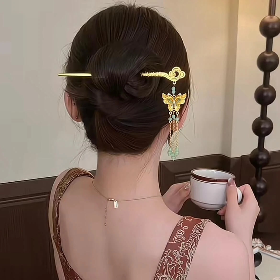 Golden cloud-butterfly hairpin worn in side-up hairstyle, vintage setting