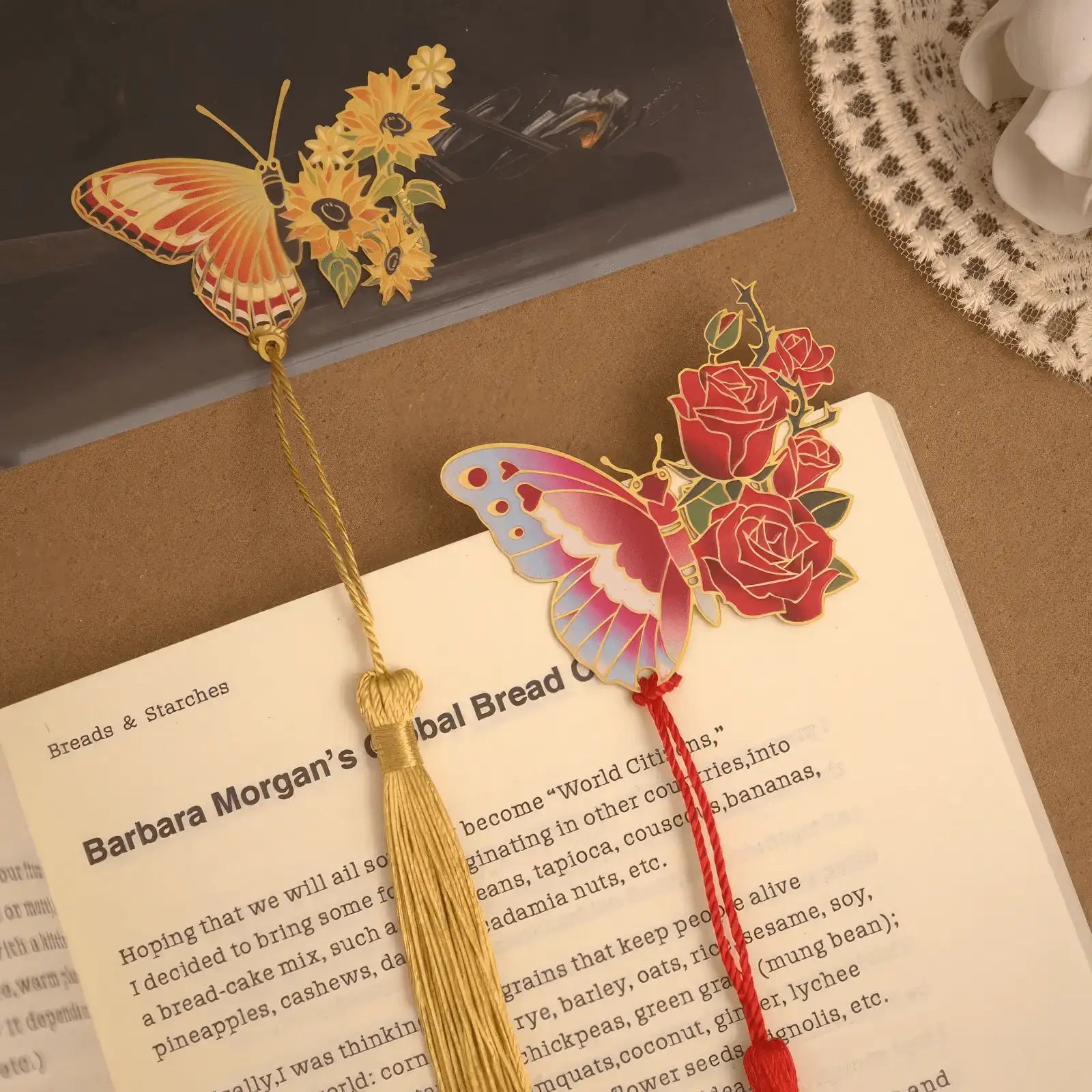 Colorful butterfly metal bookmark with yellow tassel on book