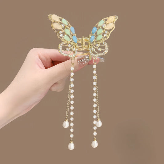 Colorful wing butterfly tassel claw clip, close - up view showing pearl tassels and wing details