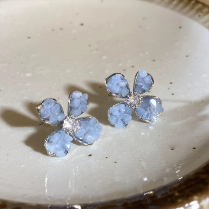 Crystal flower earrings, blue style, displayed on white plate