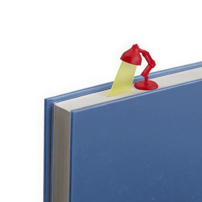 Red - and - yellow desk lamp - shaped bookmark clipped on blue book, light background