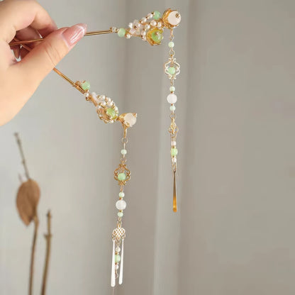 Detachable tassel hairpin held in hand, showing both the hairpin and separate tassel components