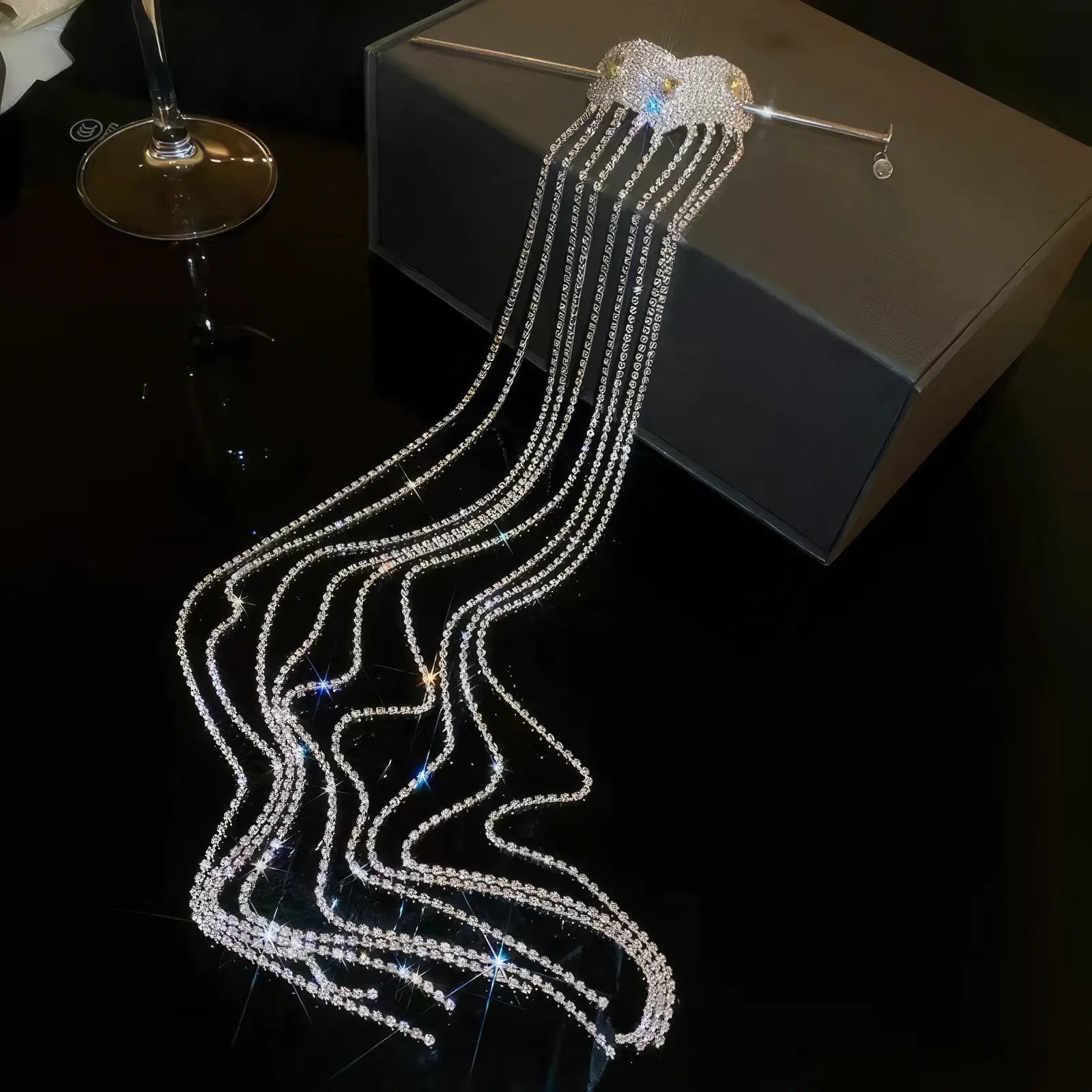 Silver diamond heart extra - long tassel hairpin displayed on a dark surface, box in background