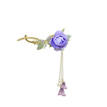 Isolated view of an elegant purple flower twist hairpin on white background