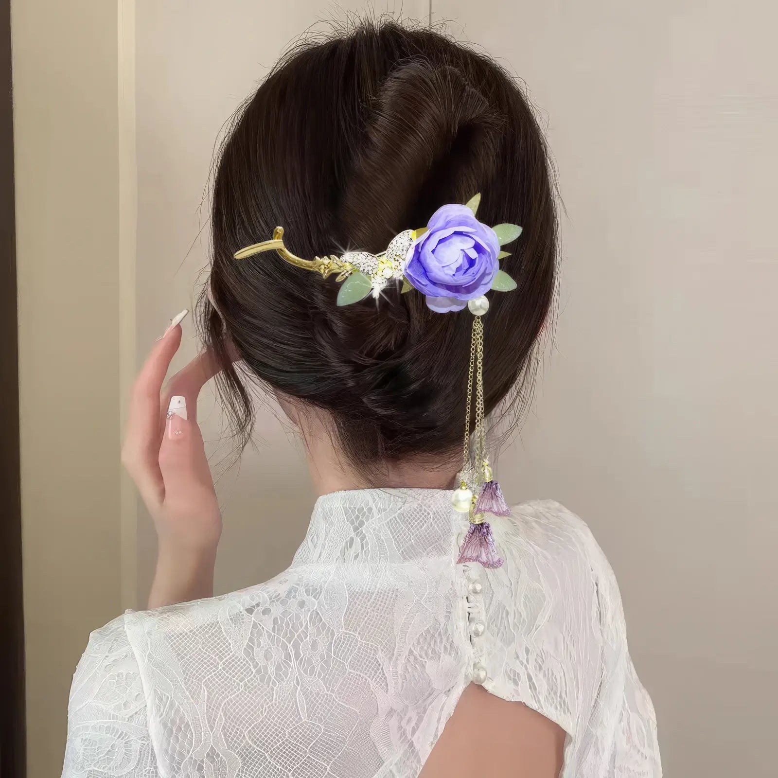 Woman wearing an elegant purple flower twist hairpin, back view, white lace top