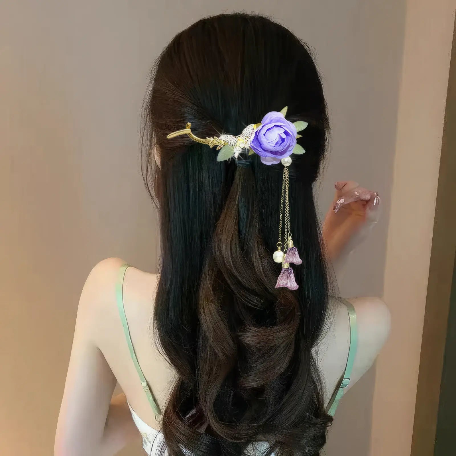 Woman wearing an elegant purple flower twist hairpin, side back view, light - colored dress