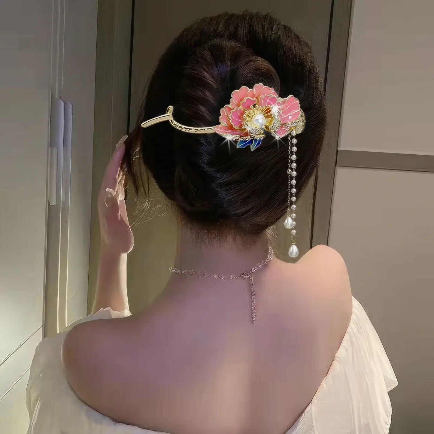 Woman wearing an elegant colorful flower twist hairpin, side back view, light - colored dress