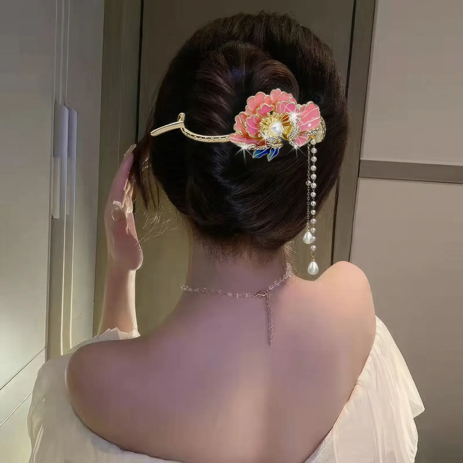 Woman wearing an elegant colorful flower twist hairpin, side back view, light - colored dress