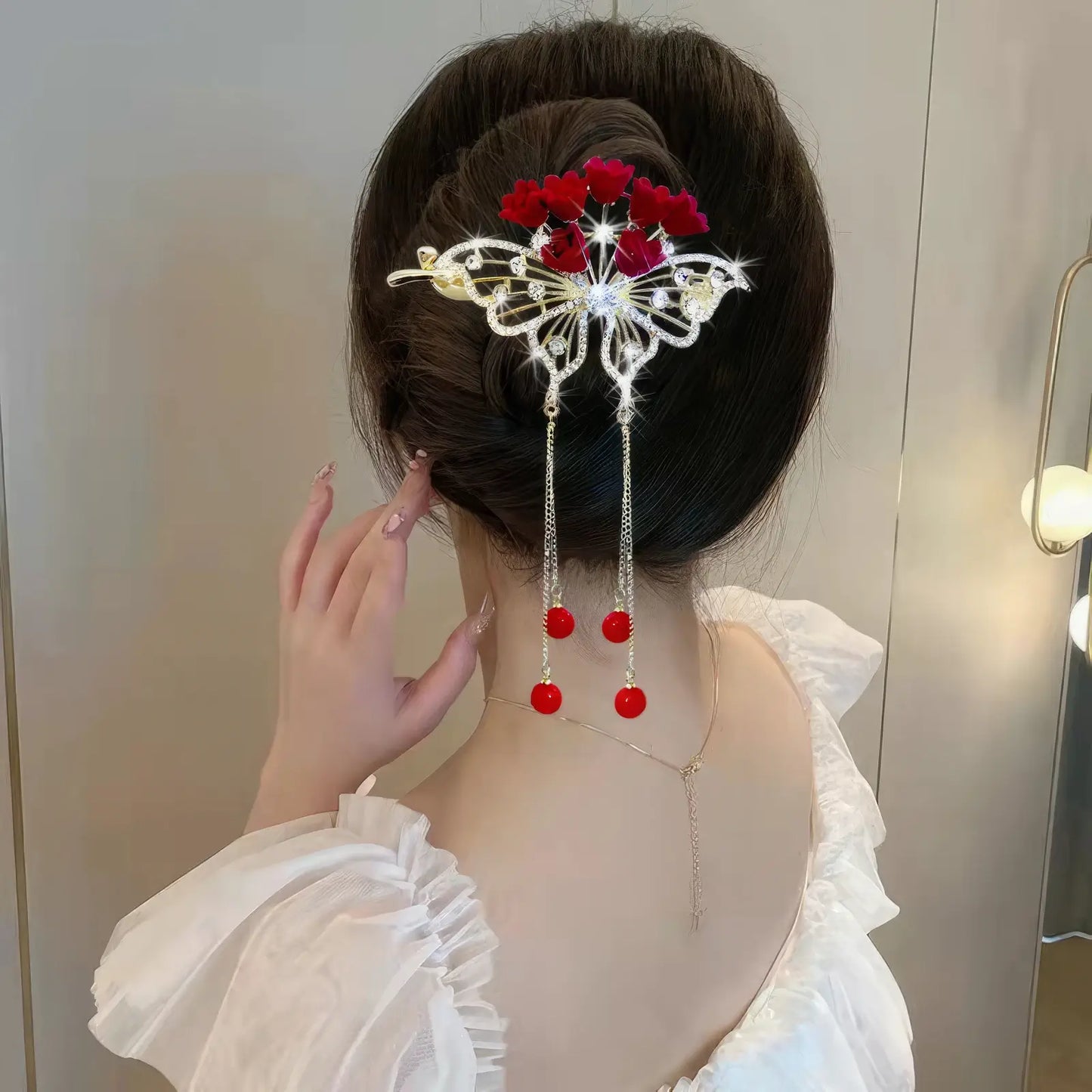 Woman wearing an elegant red flower twist hairpin, back view, white top