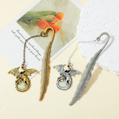 Set of feather four - winged dragon glow - in - the - dark bookmarks, displayed on light background with cards
