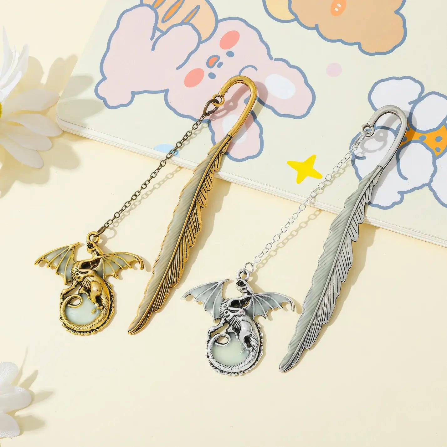 Set of feather four - winged dragon glow - in - the - dark bookmarks, displayed on light background with cute patterns