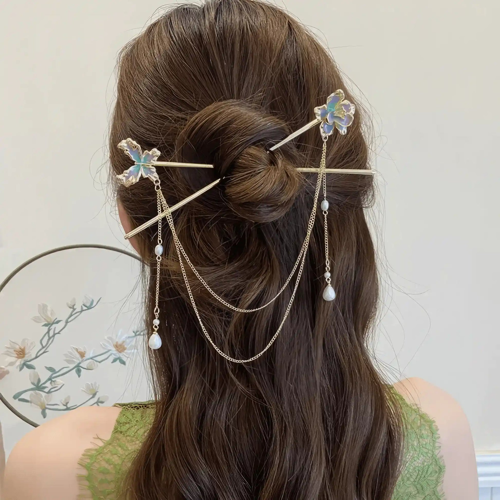 Floral butterfly hairpin worn in updo hairstyle, tassels swinging
