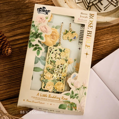 Floral story bookmark in beige package, displayed on wooden surface with stationery in background