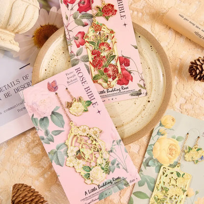 Floral story bookmark in green package, displayed on light surface with stationery in background