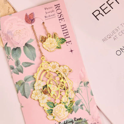 Floral story bookmark in pink package, displayed on light surface with stationery in background