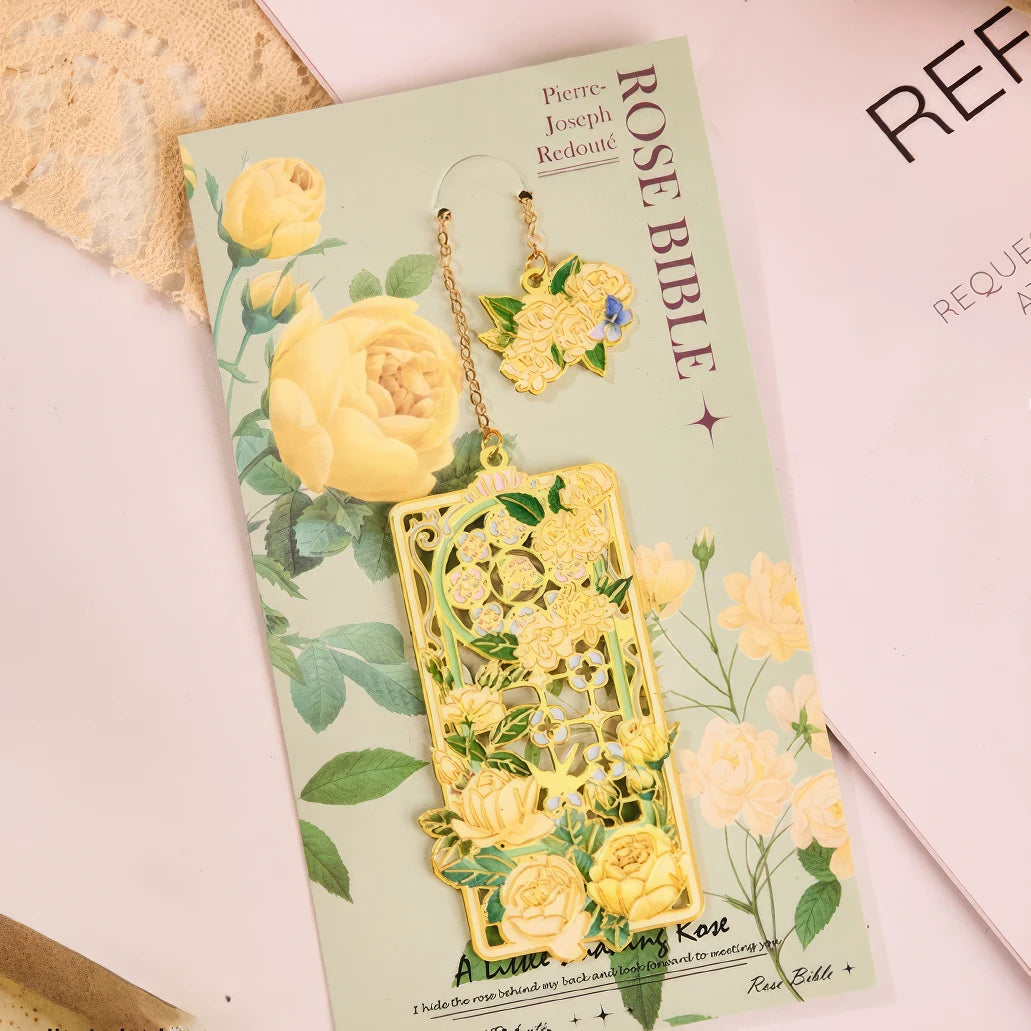 Floral story bookmark in pink package, displayed on light surface with stationery in background