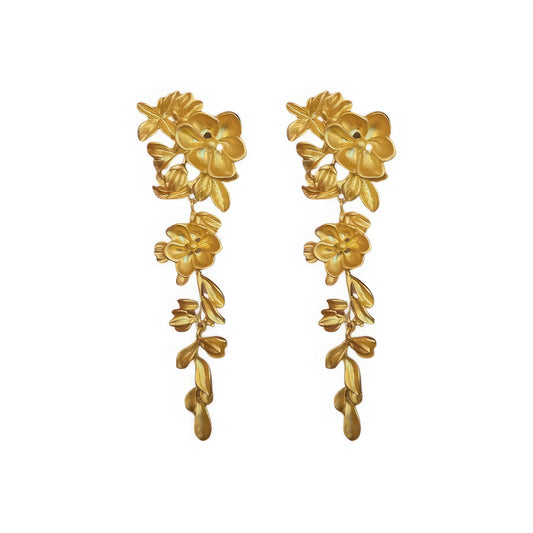 Gold flower leaf tassel earrings isolated on white background