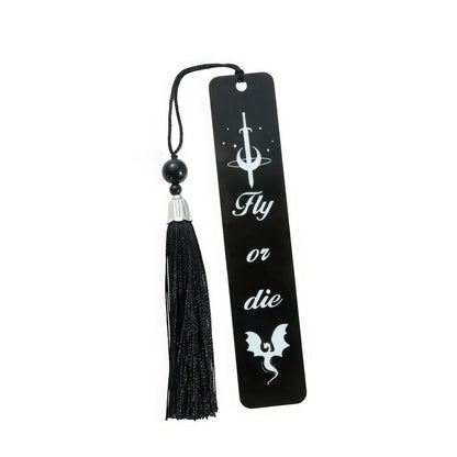 Set of black four - winged dragon metal bookmarks with tassels, isolated on white