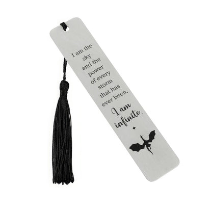 Silver four - winged dragon metal bookmark with black tassel, isolated on white