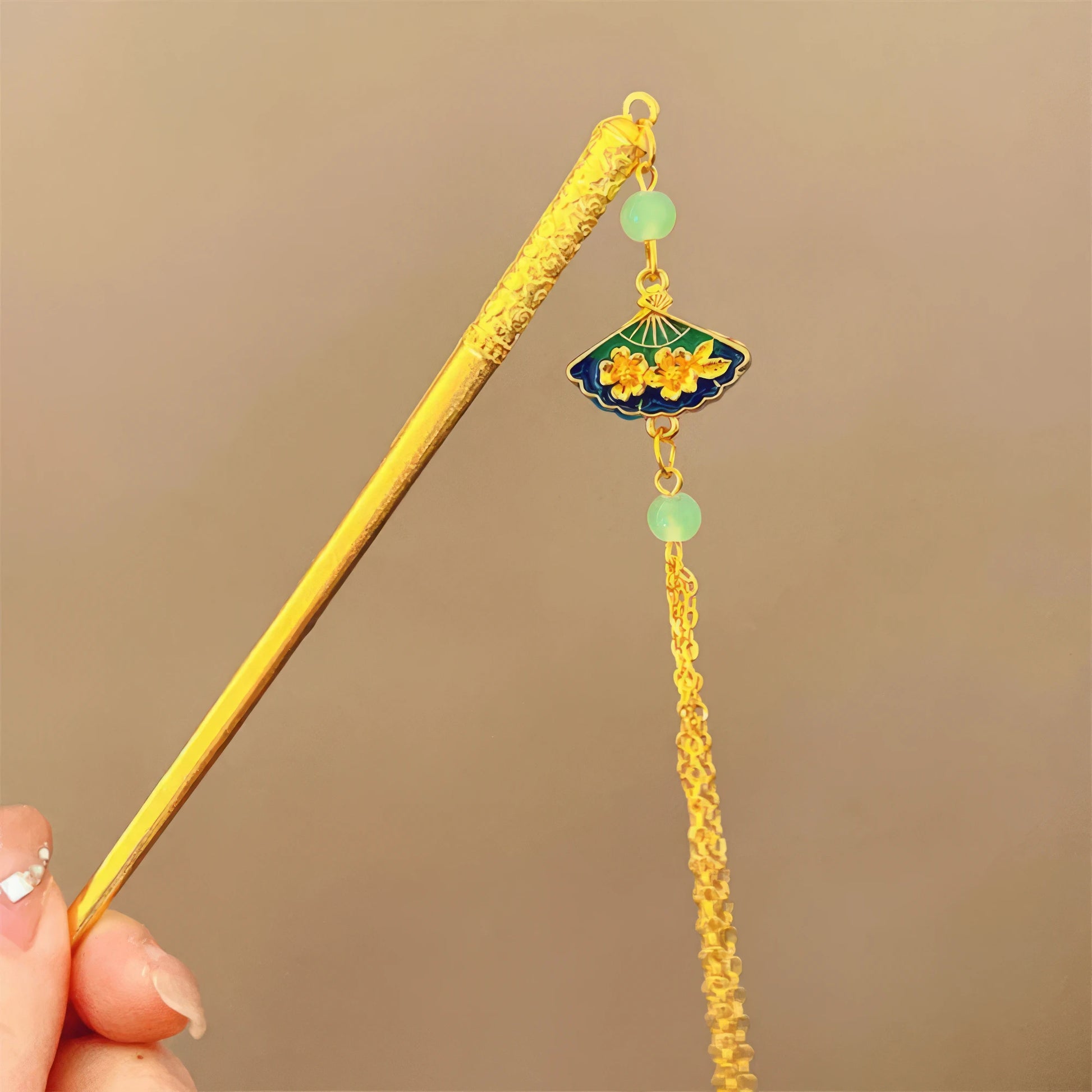 Golden small fan-shaped hairpin with green jade tassel, closeup view
