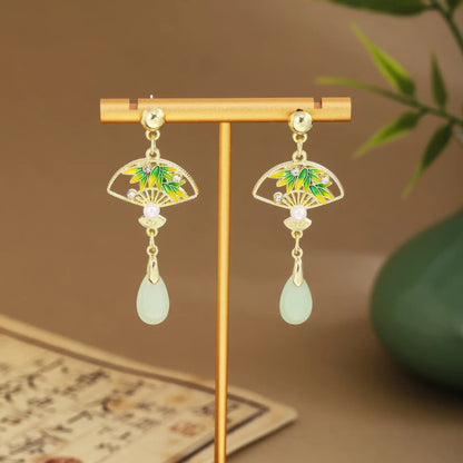 Colorful fan earrings with light green drops on gold hanger, green vase and scroll