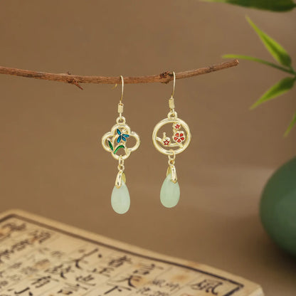 Mixed fan earrings with light green drops on wooden hanger, green vase and scroll