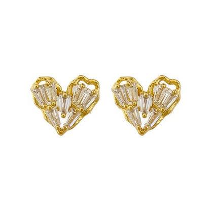 Pair of gold - framed heart - shaped earrings, isolated on white background
