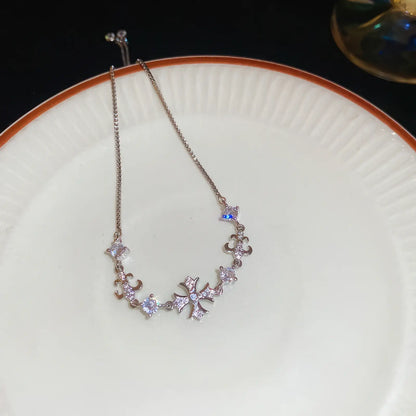 Iris cross bracelet, silver - tone, displayed on white plate