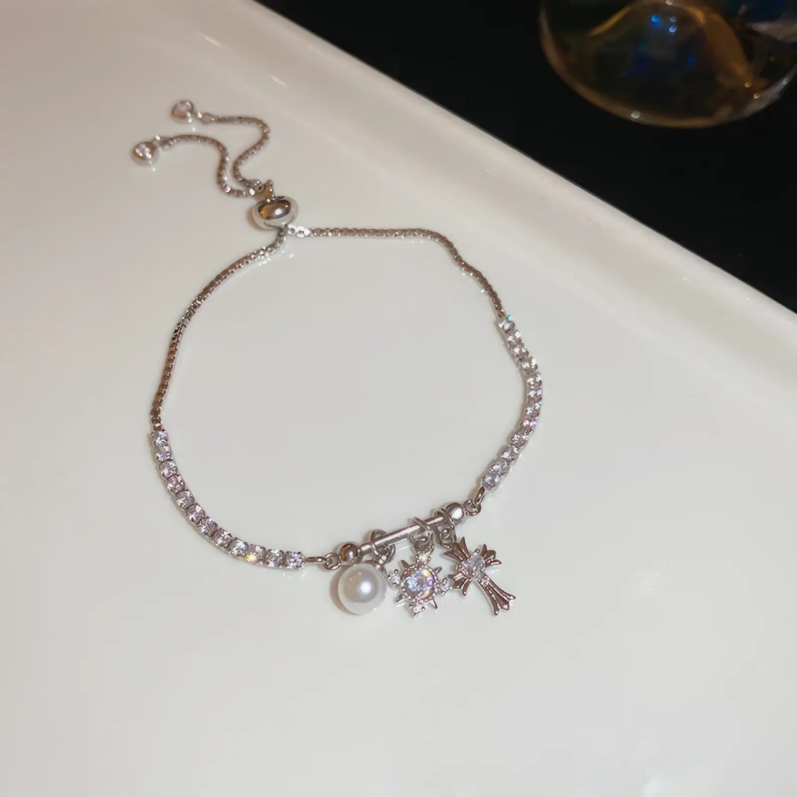 Iris cross bracelet with pearl, silver - tone, displayed on white pad