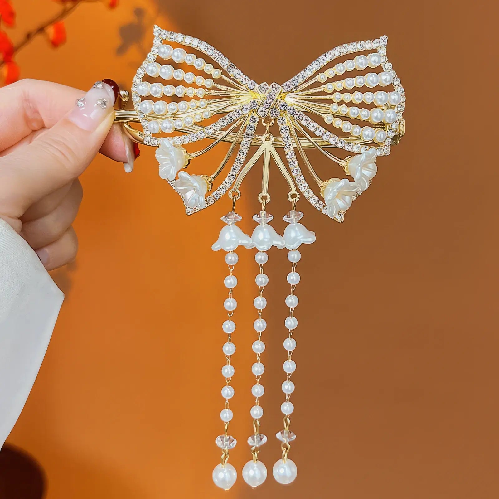 Large - bow - shaped tassel twist hair clip with crystal and pearl embellishments
