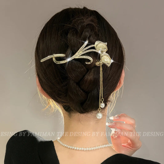 Leaf - shaped gold - toned twist hair clip worn in an updo hairstyle
