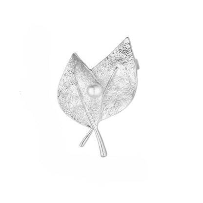 Silver leaf - shaped brooch with pearl, isolated on white background, highlighting texture