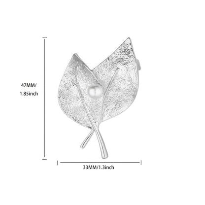 Silver leaf - shaped brooch with pearl, with size specifications (47mm x 55mm), isolated on white