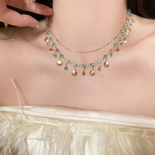Mermaid princess necklace worn, complementing a feathery top, showcasing elegance