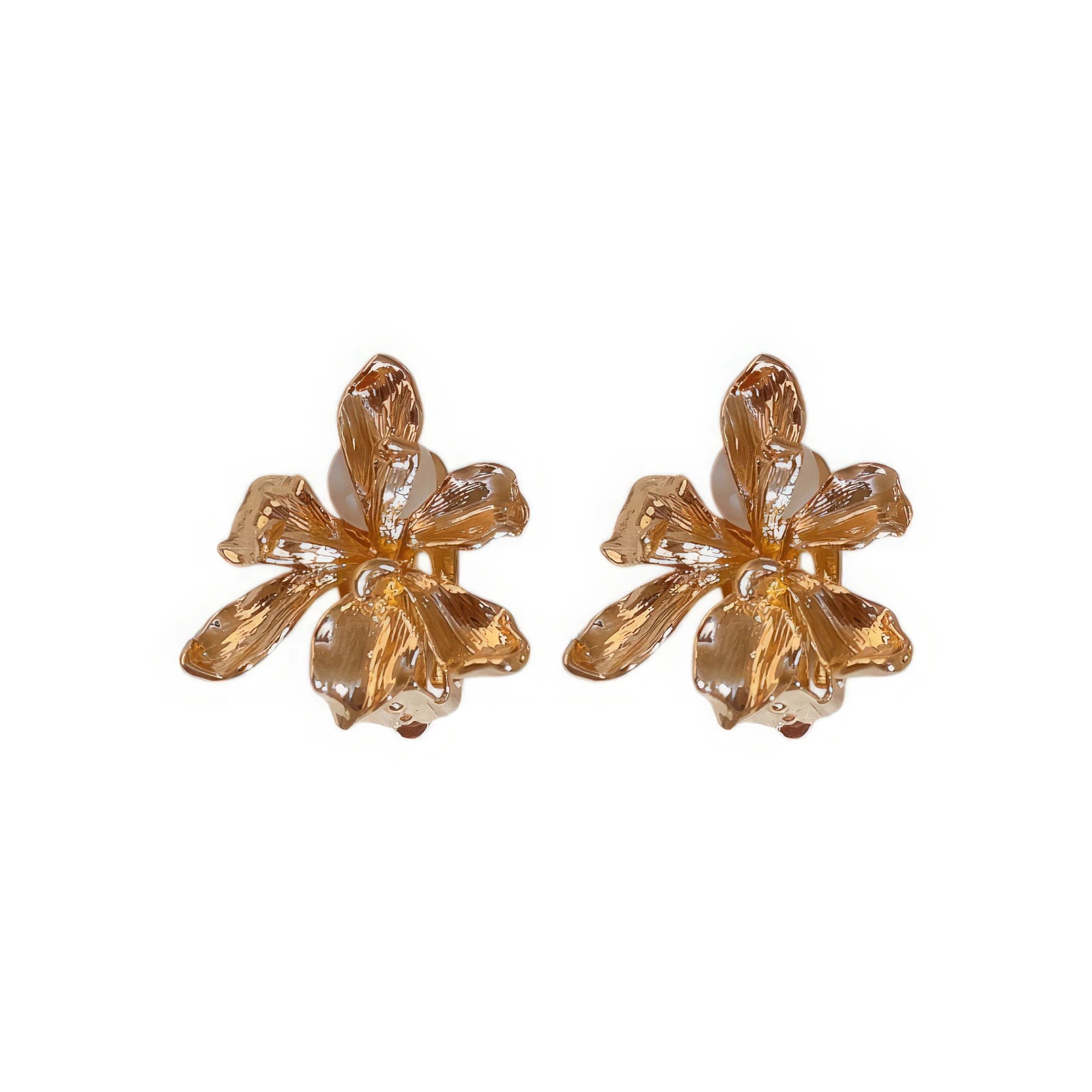 Gold metal flower ear clips isolated on a white background