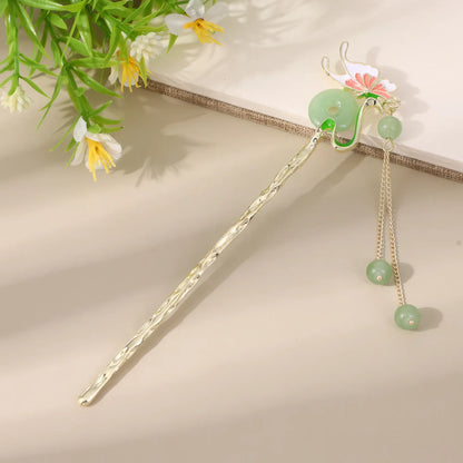 Moyunxuan hairpin, silver with green bead and floral design, on beige background with greenery
