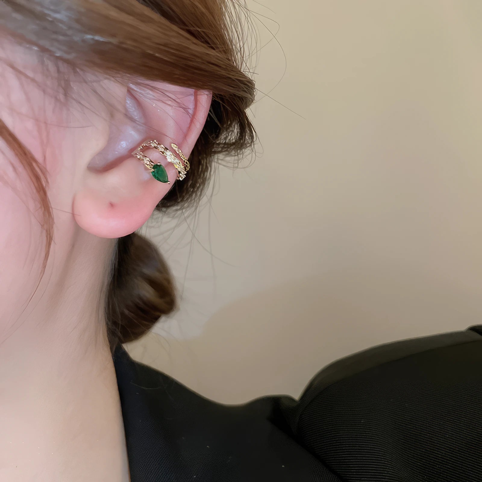 Multi - layer butterfly ear cuff with colored accents, worn on ear