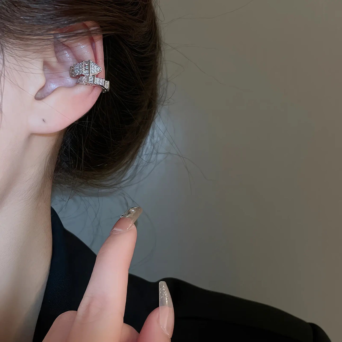 Holding multi - layer butterfly ear cuff, showcasing 3D butterfly structure