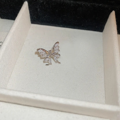 Single multi - layer butterfly ear cuff in display box, isolated view
