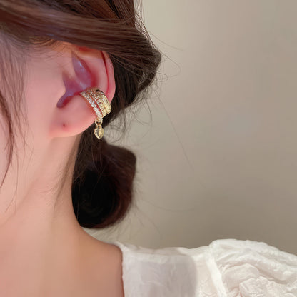 Multi - layer butterfly ear cuff on ear, paired with other delicate ear cuffs