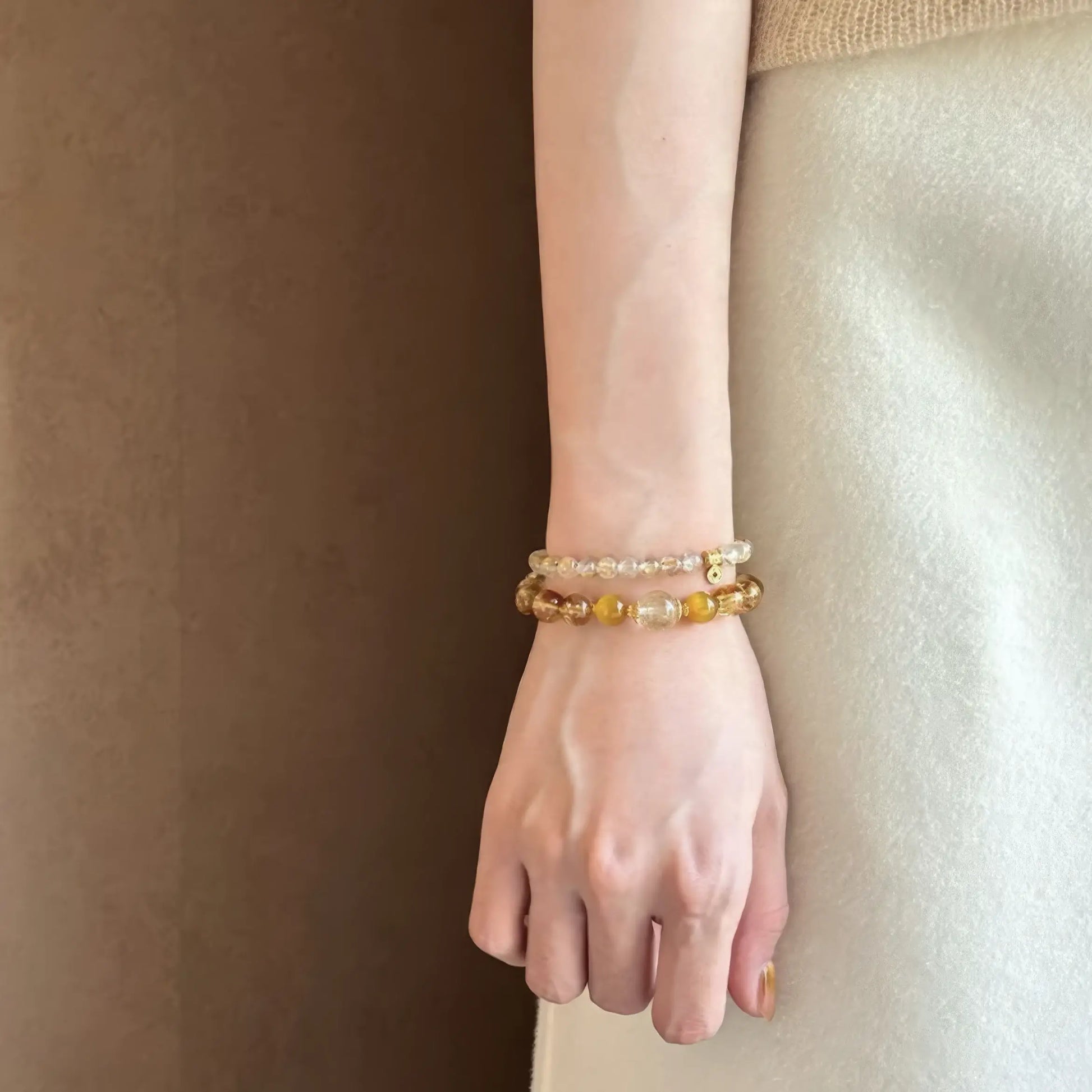 Natural stone citrine rutilated quartz bracelet worn on wrist, showcasing minimalist look