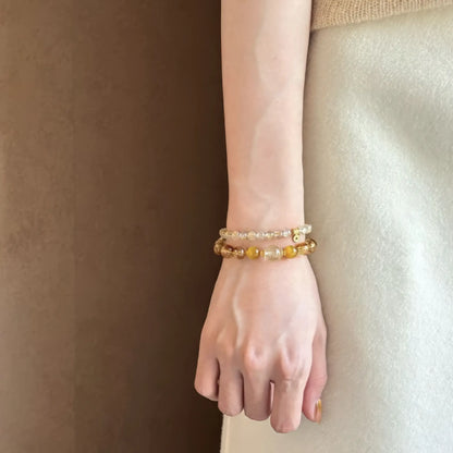 Natural stone citrine rutilated quartz bracelet worn on wrist, showcasing minimalist look